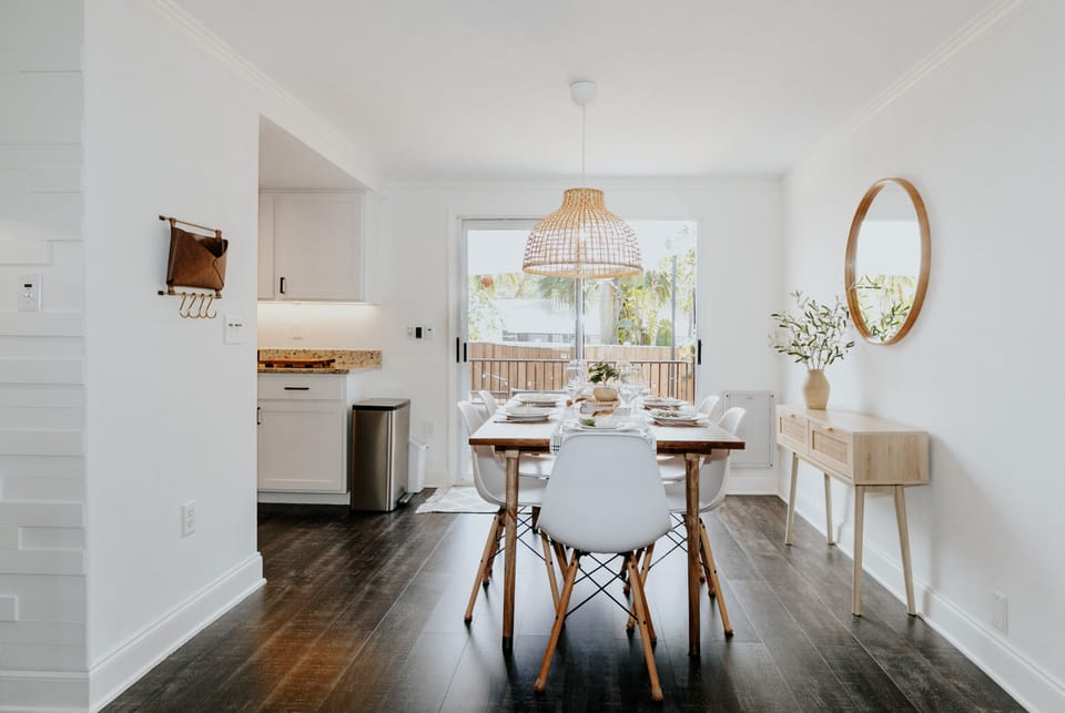 Beautiful dining room with styled decor and white dishes 