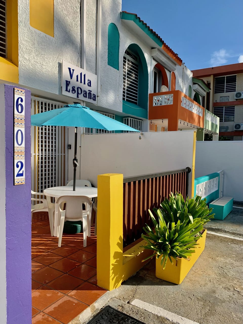 Front porch has a table seating for 4, umbrella, water hose for rinsing off sand