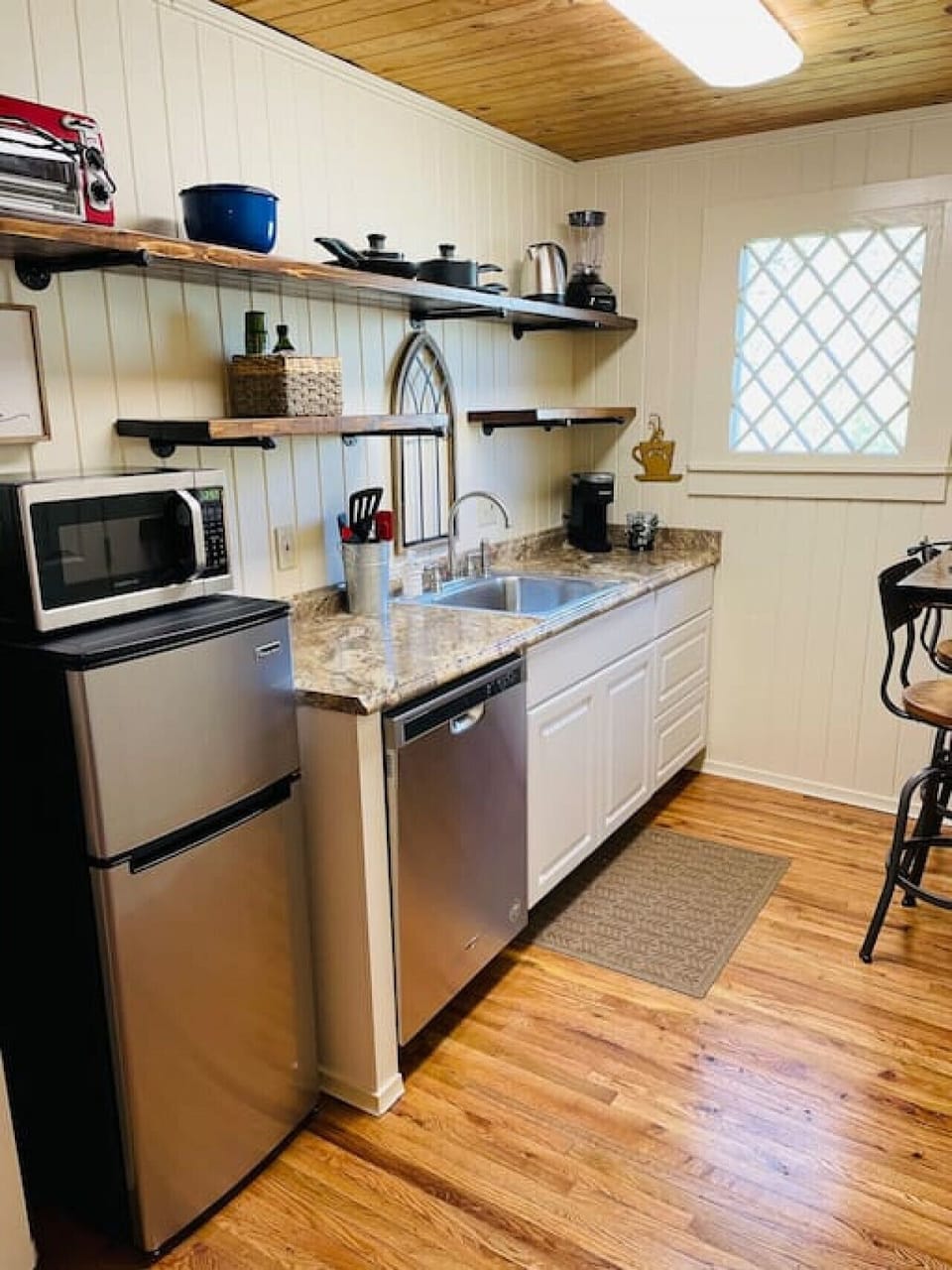 Kitchen complete with dishwasher, garbage disposal, microwave, refrigerator, Keurig, toaster oven, single burner hot plate, hot water kettle, blender,  dishes, pots & pans & utensils