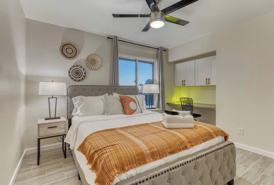 Bedroom 3 with a queen size bed, and desk.  Private smart television inside the bedroom as well., 