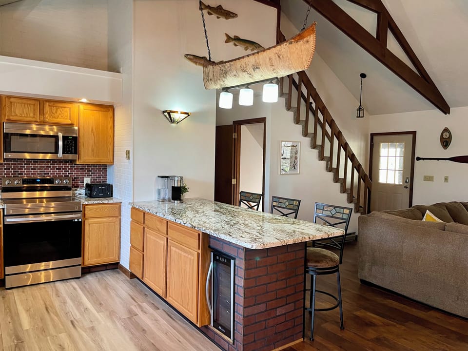 Open plan kitchen, featuring an island counter and beverage cooler
