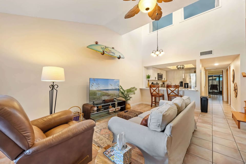 Open living area with vaulted ceilings and a kitchen bar for casual dining.