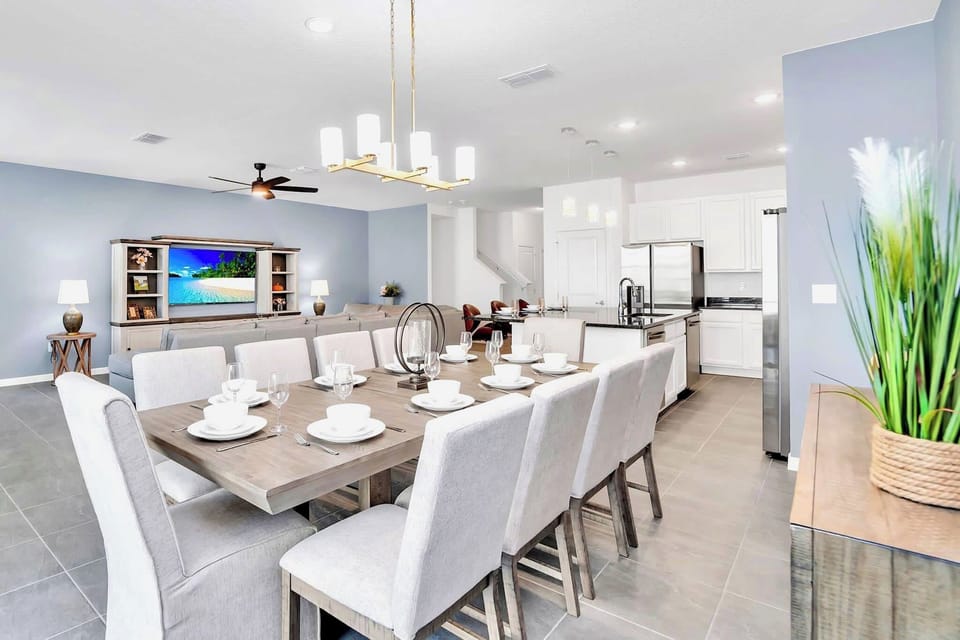Elegant Dining Area With Seating For Ten Overlooking The Spacious Living Room And Modern Kitchen