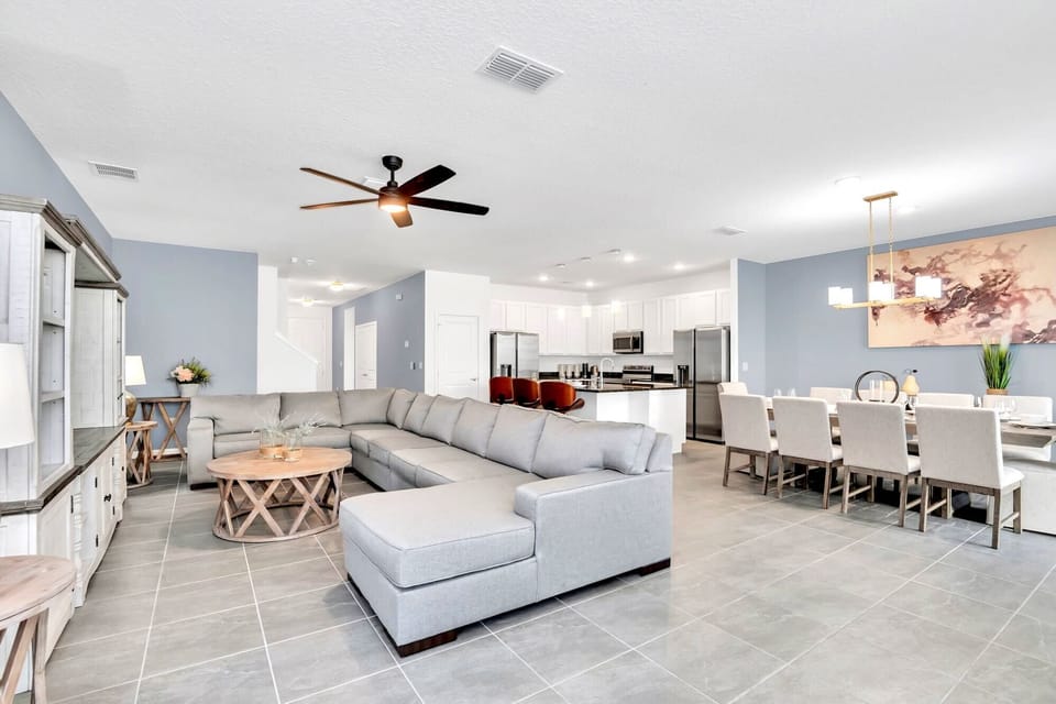 Bright And Open Living Area With Plush Sectional And 65" Smart TV