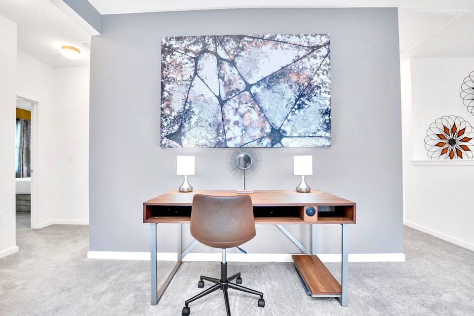 Dedicated Workspace With Desk, Chair, And Stylish Artwork