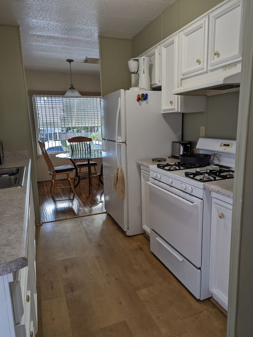 Fully equipped kitchen leads into the dining area.