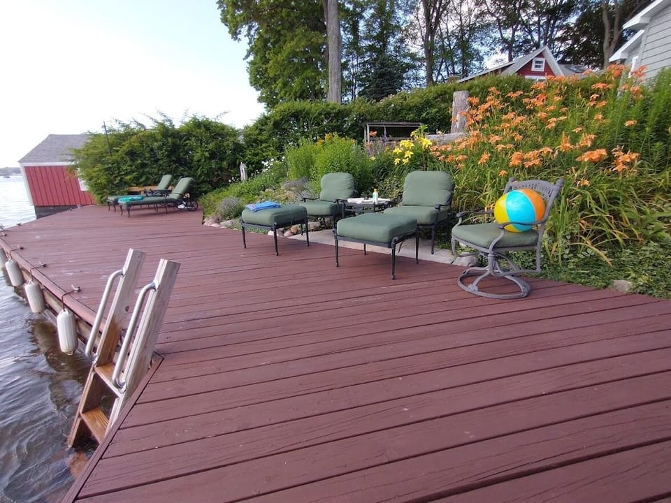View of lower deck with club chairs and ottomans