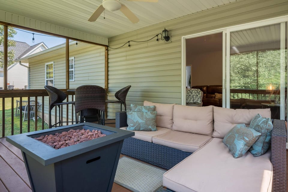 Screened in porch with fire pit and outdoor seating/dining