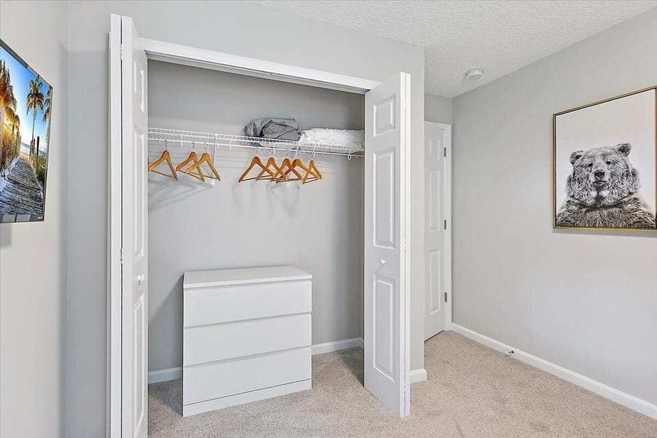 Young adults/kids room closet. Dresser, hangers and extra linens.