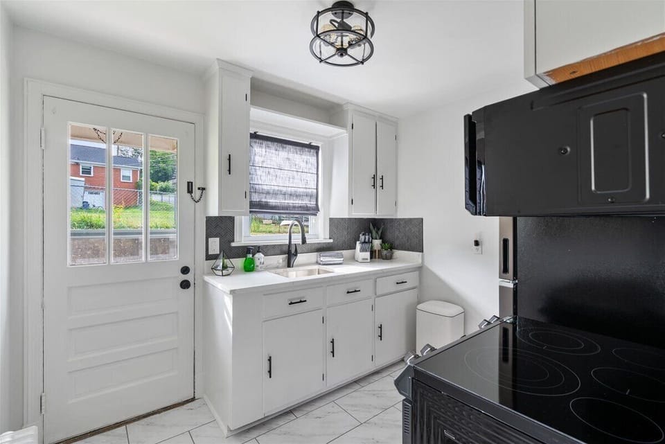 Beautiful kitchen w/ the backdoor leading to patio seating!
