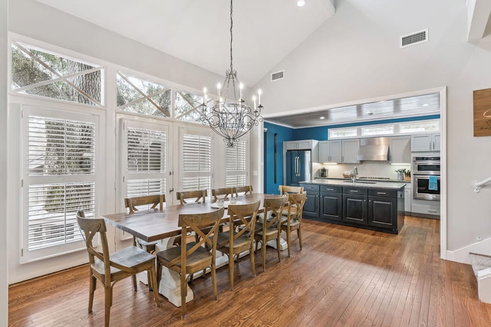 Gather around your elegant dining table under vaulted ceilings, with a modern kitchen steps away for easy meal prep.