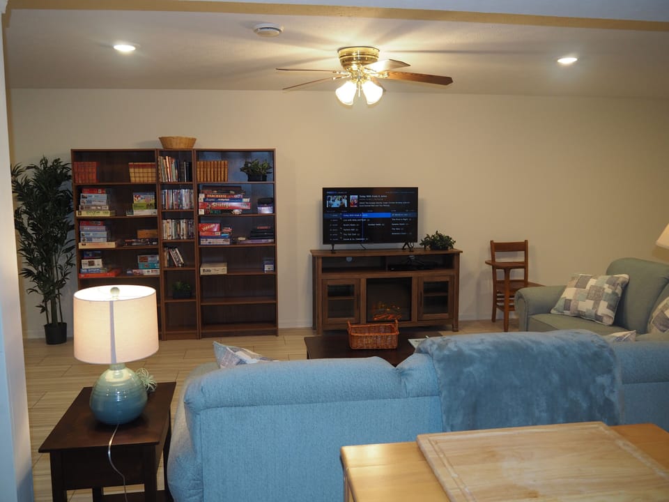 LIVING ROOM:  The apartment has a very comfortable living room with a sleeper sofa, comfy chair, ceiling fan, table, and television.