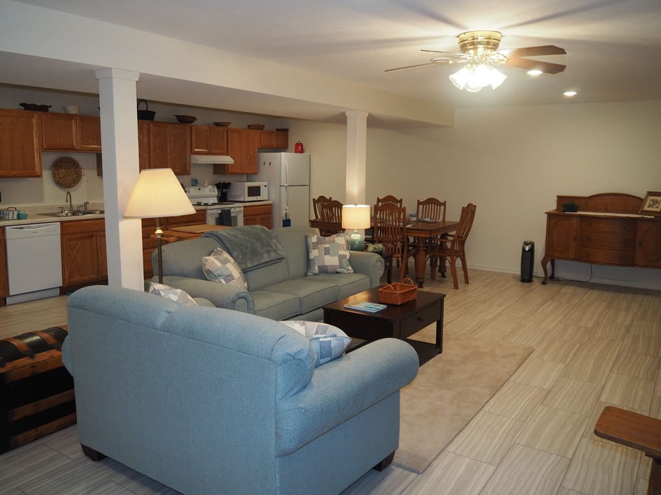 LIVING ROOM:  The apartment has a very comfortable living room with a sleeper sofa, comfy chair, ceiling fan, table, and television.
