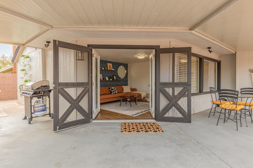 Indoor-outdoor AZ living with french doors open onto shaded patio
