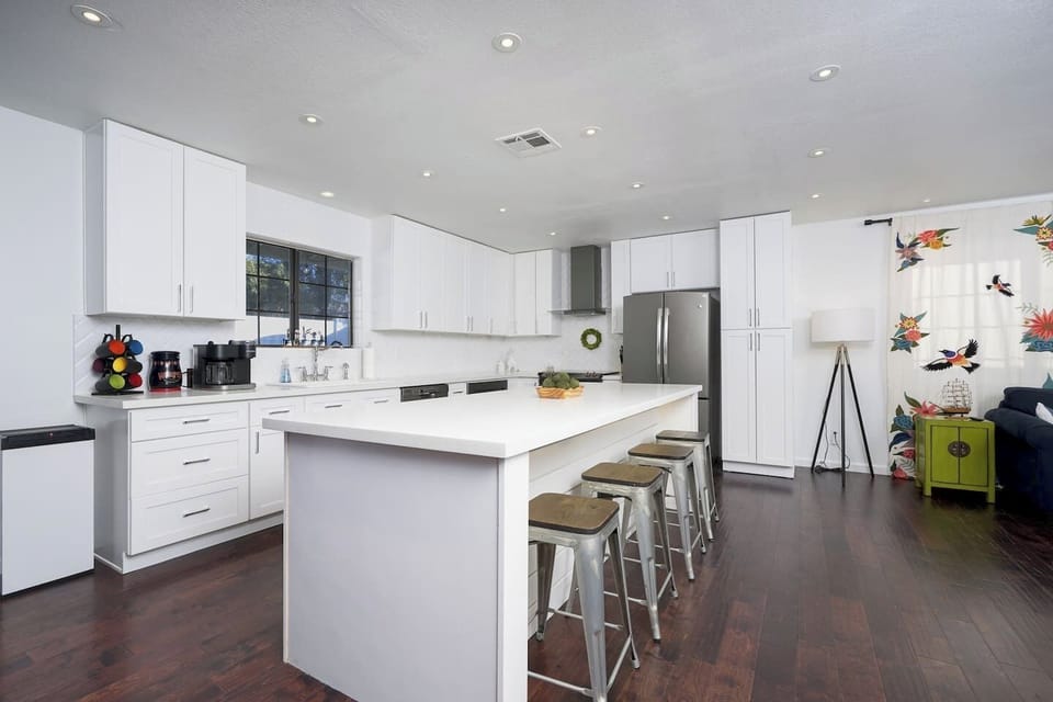 The kitchen has all the essentials such as pots and pans, a crockpot, rice maker, baking sheets, silverware, plates, bowls, cups are more!