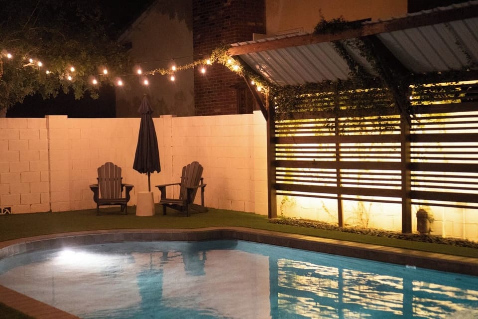 String lights + ambient lighting on the fence creates an amazing ambiance for the light night swim.