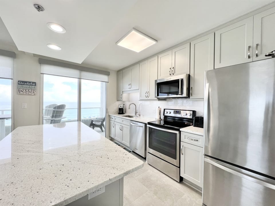 Kitchen with Stainless appliances, single basin sink, under counter lighting and so much more!