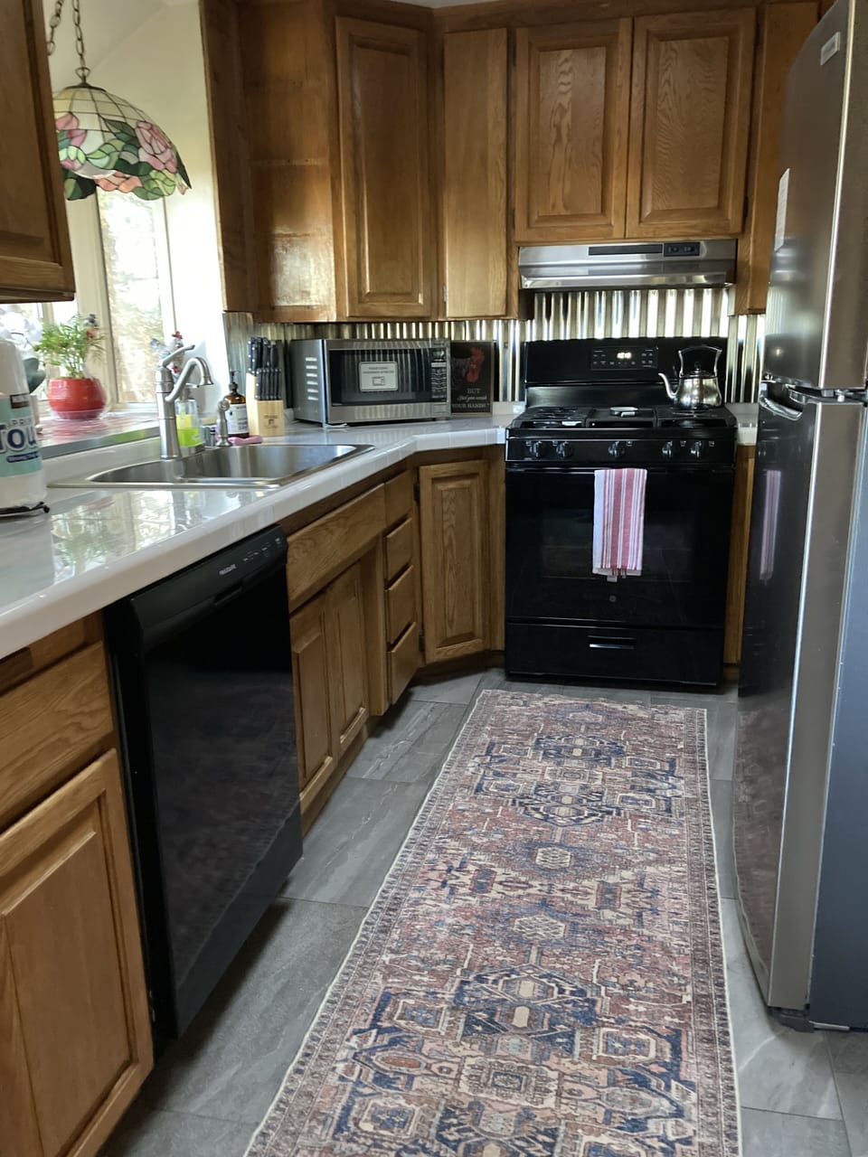 Fully stocked galley kitchen with modern appliances