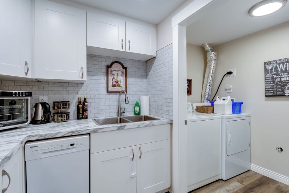 Laundry room just off of kitchen with doors to close it off.