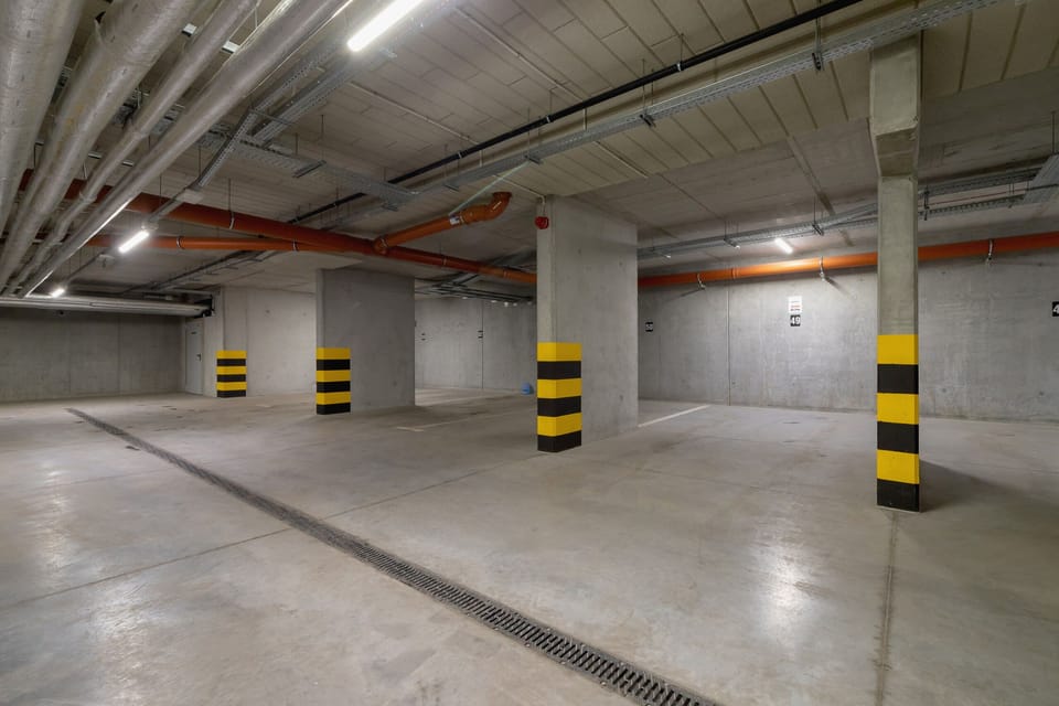 A spacious underground parking area with clearly marked spots and secure access.






