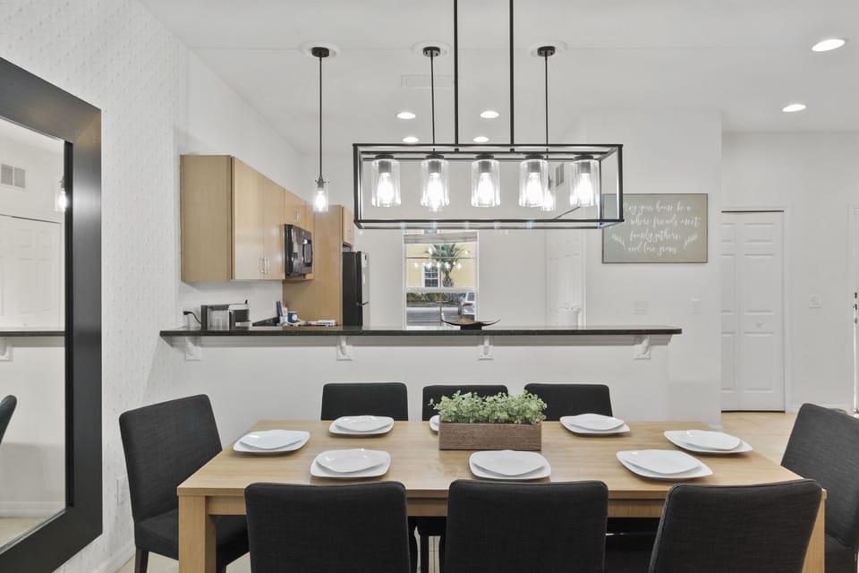 Fusion of Elegance and Warmth: Stunning Dining Area Overlooking Spacious Living Room for Memorable Family Gatherings.