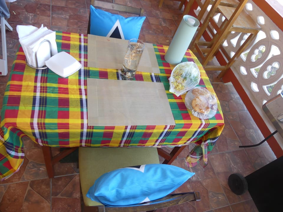 Open-air local creole breakfast on the patio with fresh breezes and island vibes