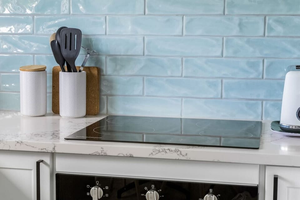The blue tile backsplash ties into the pops of colour throughout the house.