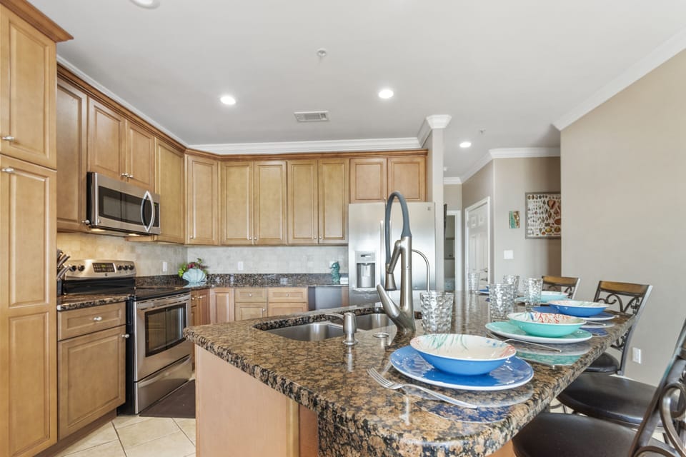 Open kitchen with breakfast bar seating, SS and granite