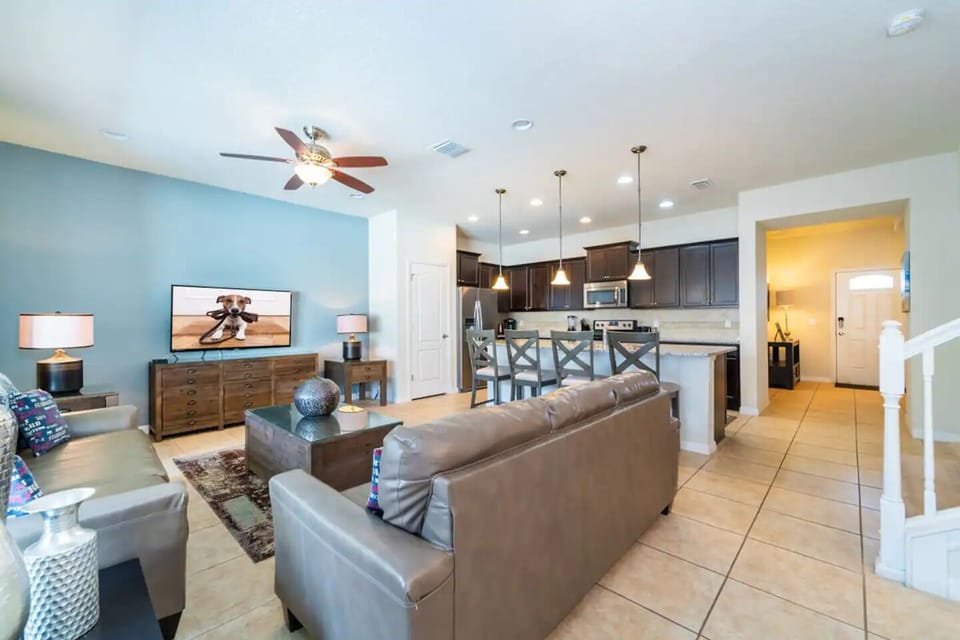 Spacious Downstairs Living Area with Comfortable Sofa, Full Size Kitchen, and Dining Area