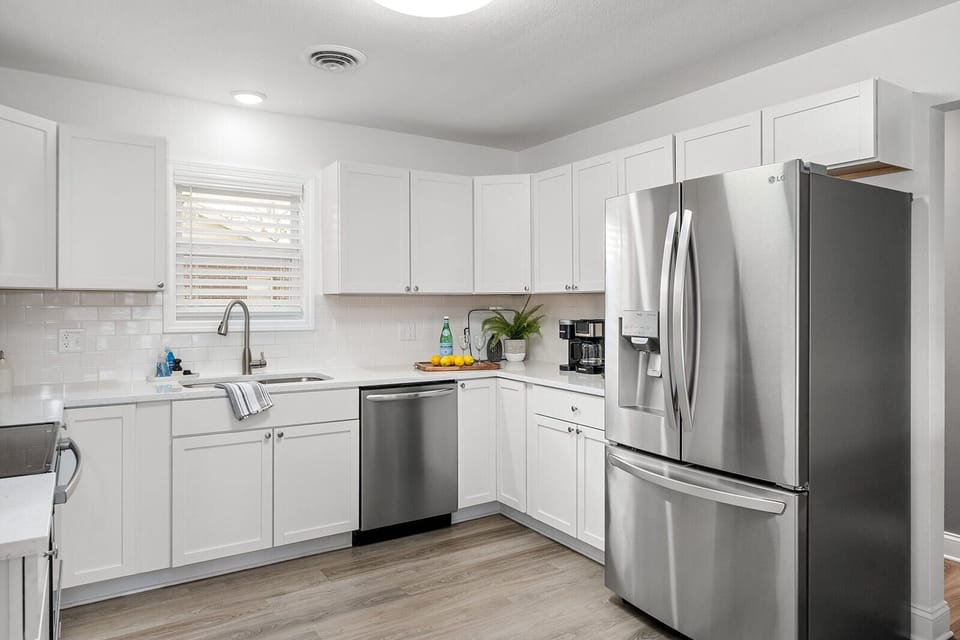 New kitchen with stove, microwave, dishwasher and fridge
