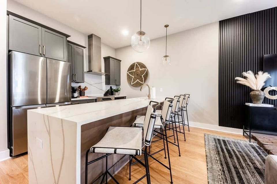 Large kitchen island with a quarts counter waterfall feature