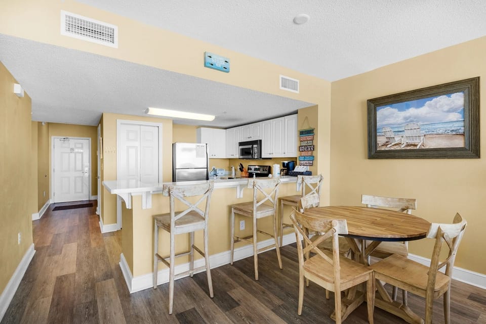 Kitchen, dining areas open to living room and ocean views