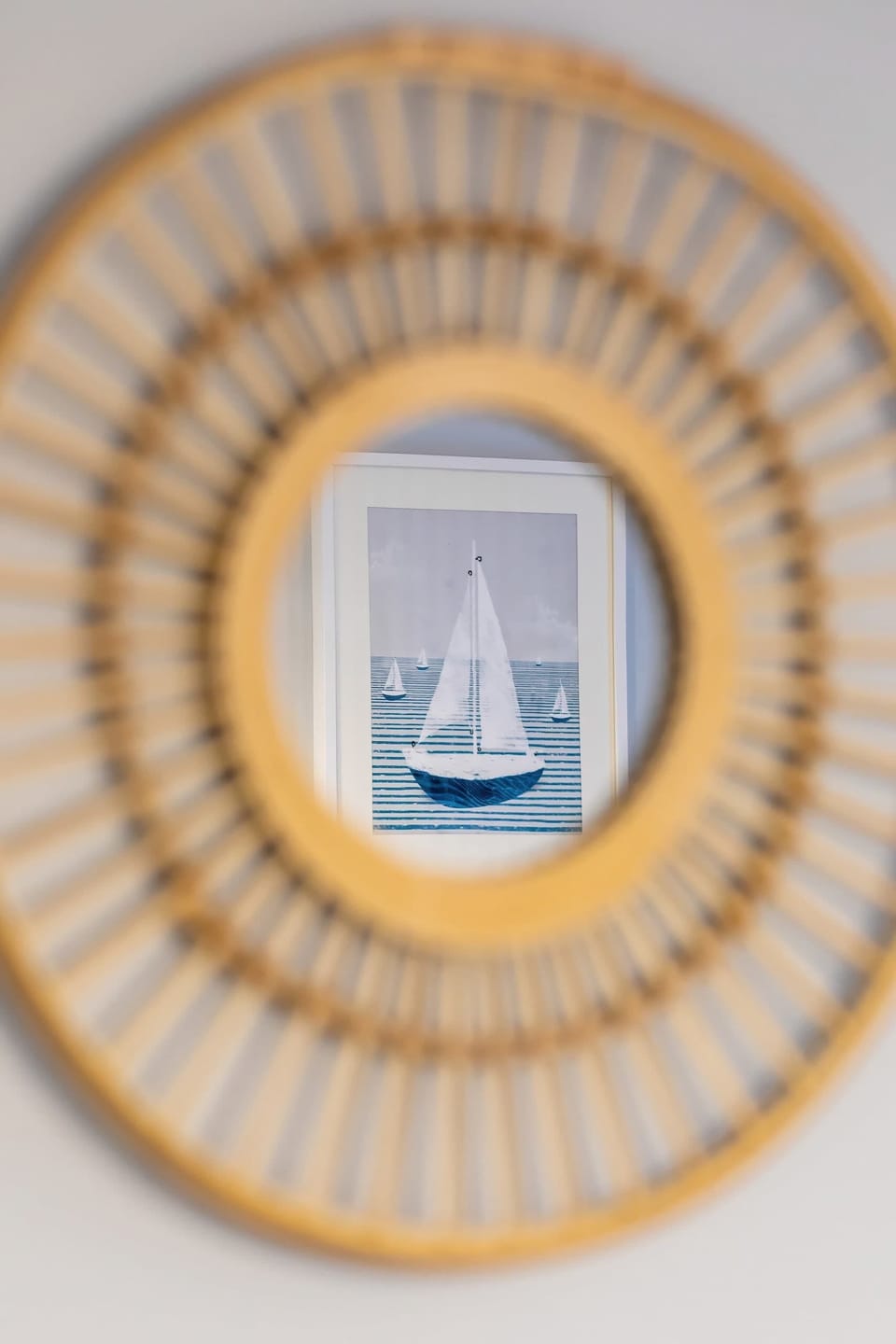 A decorative wicker mirror on a wall, adding a warm, rustic touch to the modern decor.
