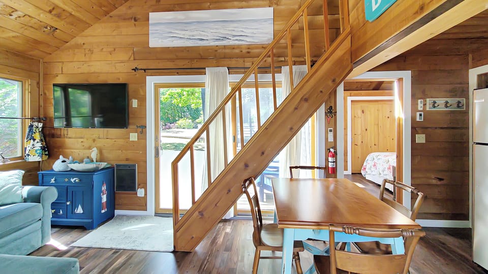Stairs lead from living room to open loft above