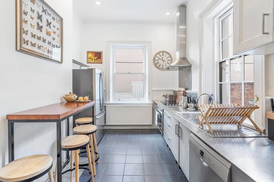 Sleek stainless steel benchtops line the kitchen that comes complete with a dishwasher and a breakfast island.