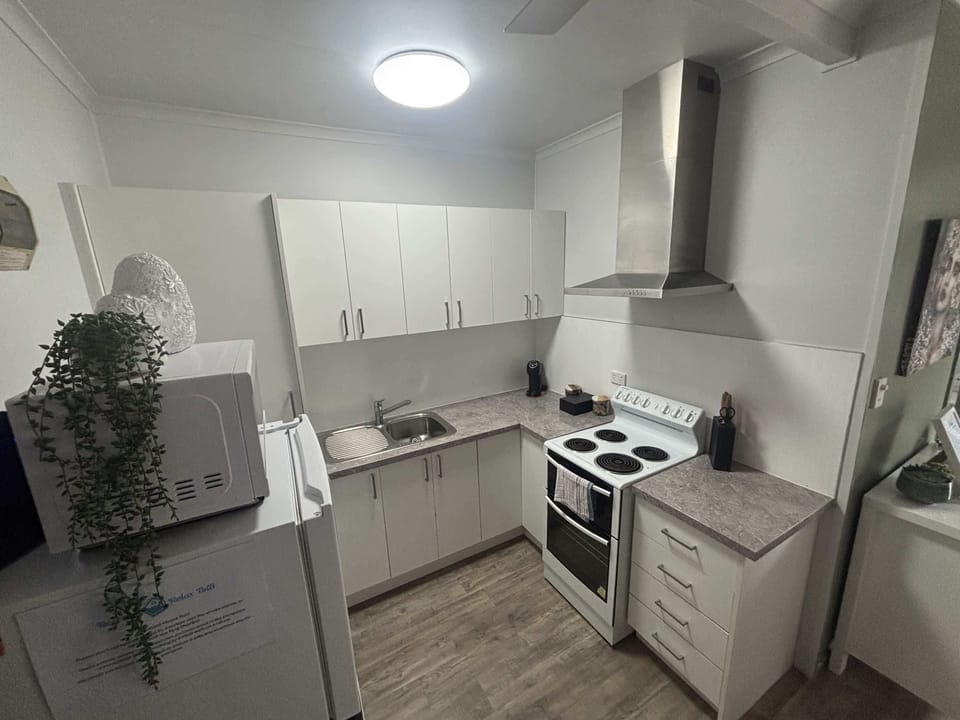 The kitchen has a full oven and cooktop, fridge, microwave and everything you need to cook a proper meal.