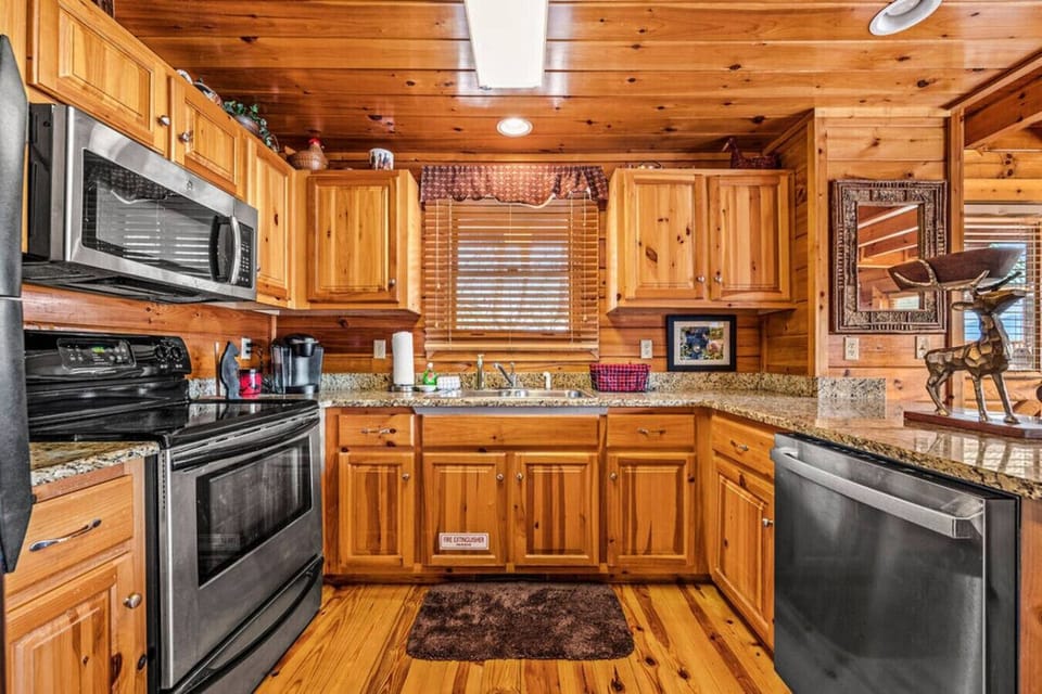 The kitchen includes a full-sized refrigerator, oven, dishwasher, microwave and more.