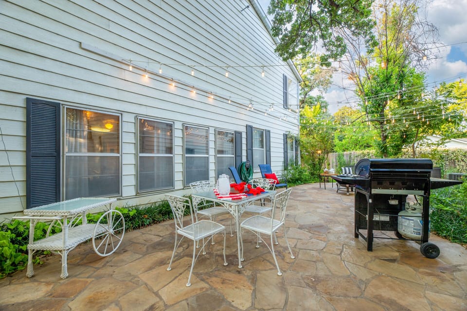 Property has beautiful stone patio with outdoor furniture and BBQ grill