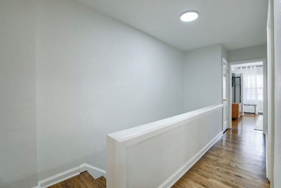 Third floor hallway leading to all bedrooms and full bath. 