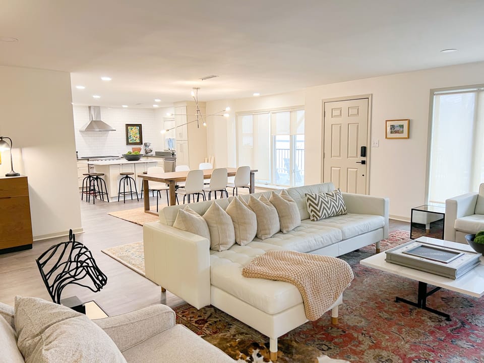 Spacious living room with smart TV, Sofa, love seat and two chairs.