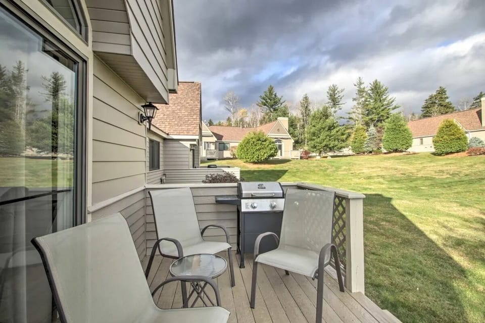 Back deck offers outdoor seating, propane grill and walk-on access to the lawn.