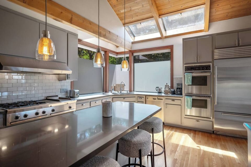 Chef's kitchen with 2 ovens, large refrigerator, and standard cooking and baking tools.