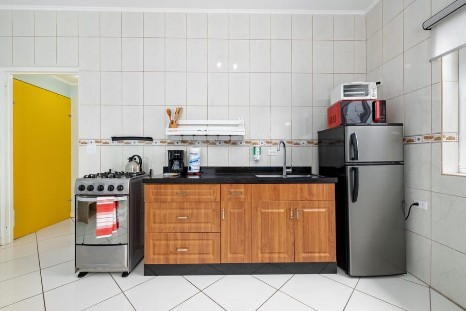 The kitchenette includes a fridge, range, toaster oven, microwave and coffee machine.