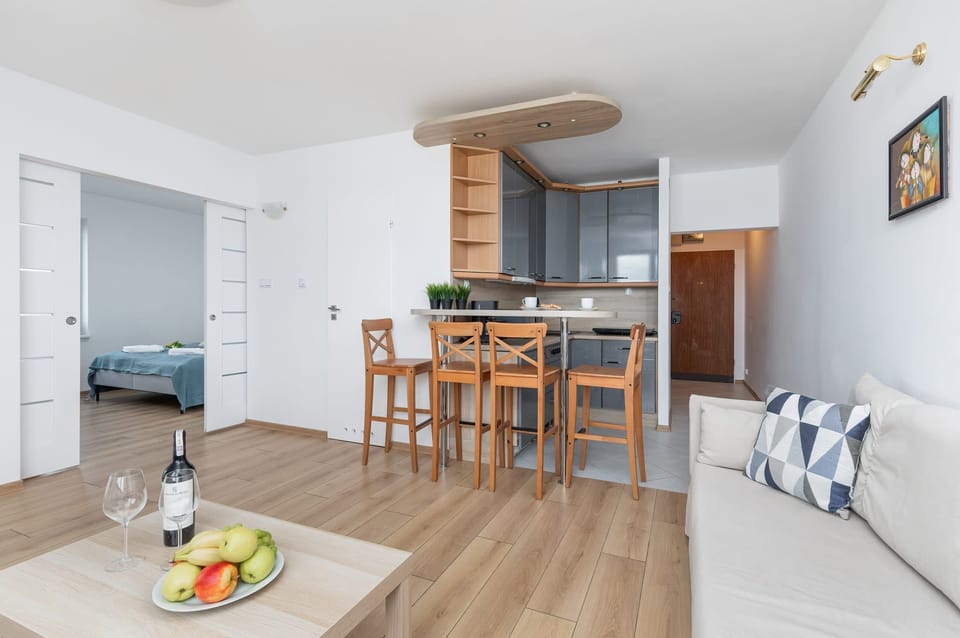 A dining area with a wooden table and chairs, seamlessly connected to the kitchen.

