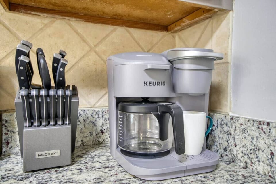 Start your day with the perfect brew from the Keurig coffee station, conveniently placed on sleek granite countertops.