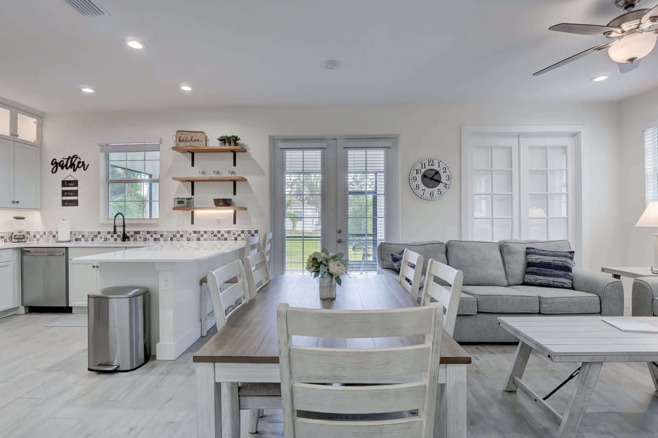 A View From the Dining Set Towards the Kitchen, Porch, Family Room and Den With Doors Closed in Back Right