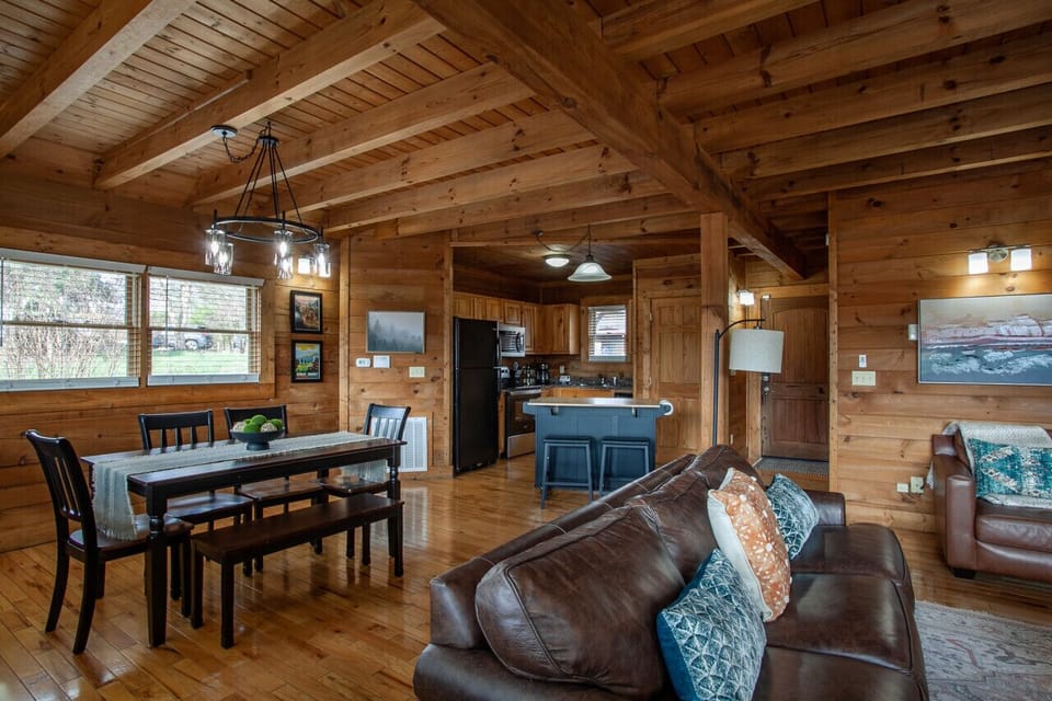 This cozy living room flows right into the dining area and overlooks the kitchen, making every space feel connected.