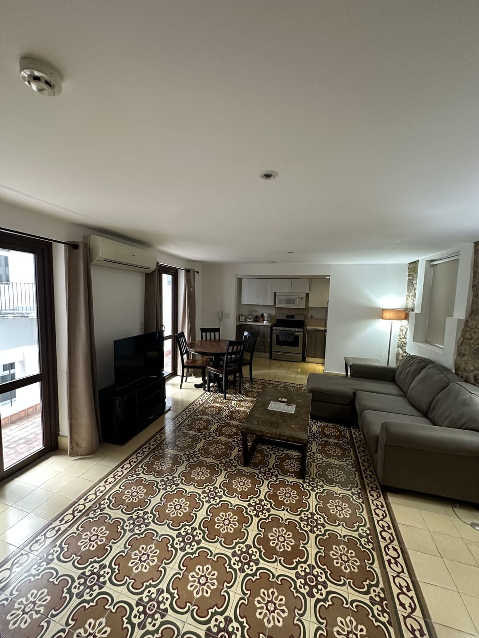 Living room with comfortabe sofa and a Smart TV with cable TV. 
