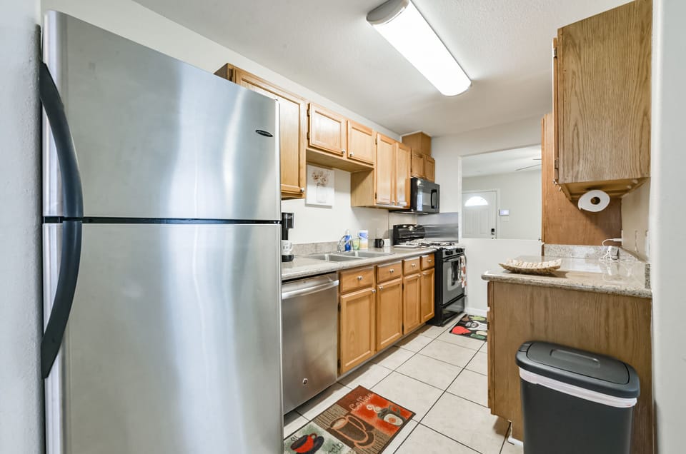 Full kitchen with stove, microwave, dishwasher, and fridge. 
