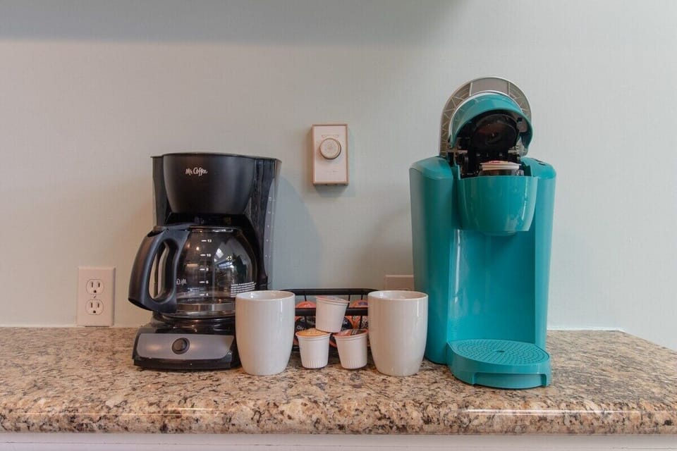 Start your mornings right with our convenient coffee station. Whether you prefer a quick cup from the Keurig or a freshly brewed pot, this setup ensures your caffeine needs are met. Relax and enjoy your perfect cup of coffee!